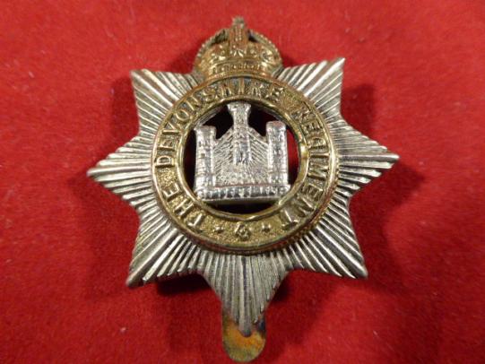 Original British Army Kings Crown The Devonshire Regiment Cap Badge.